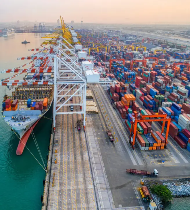 Commercial vessel container ship alongside of berth in port congestion for loading and discharging containers services in maritime transports in World wide logistics Commercial vessel container ship alongside of berth in port congestion for loading and discharging containers services in maritime transports in World wide logistics