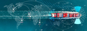 Cargo ship carrying containers crosses the ocean over a digital world map with data lines, representing global trade and supply‑chain connectivity.